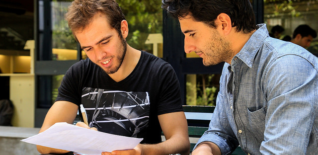 Two people looking at a paper